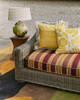 Wicker sofa upholstered in Todo striped weave in terracotta, styled with floral Eden fabric cushions in lemon yellow. Photographed by Michael Sinclair.